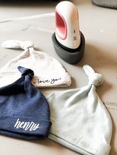 three personal items are sitting on the table next to an electric hair dryer and towel