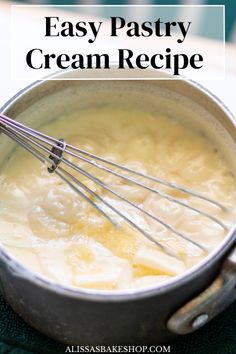 a pot filled with cream and whisks on top of a green table cloth