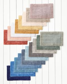 various colors of towels laid out on top of each other in the shape of rectangles