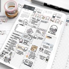 an open planner with stickers on it and a cup of coffee next to it