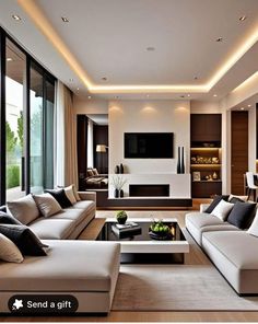 modern living room with white couches and black coffee table in front of large windows