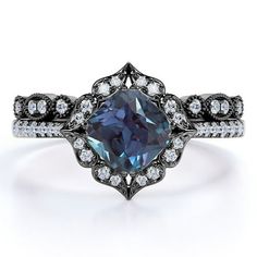 an engagement ring with a blue diamond surrounded by diamonds