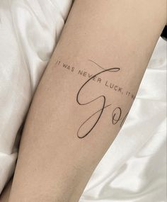 a person with a tattoo on their arm that says, it was never luck until god