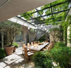 an outdoor dining area with large table and chairs