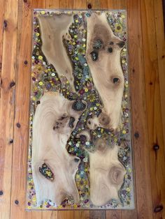 an art work made out of wood and glass on a wooden floor in a room