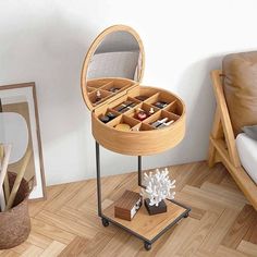 a round wooden table with compartments for jewelry and other items on it in a living room