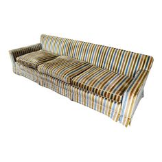 a striped couch sitting on top of a white floor