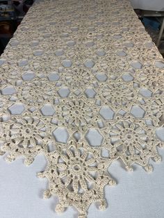 the table is covered with white crocheted doily