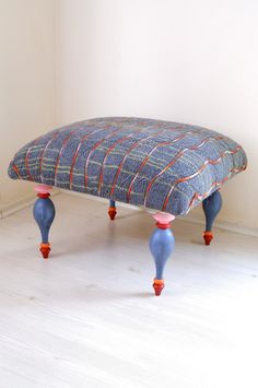 an upholstered footstool in the shape of a bench