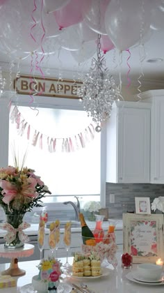 the table is set for a bridal party with balloons and confetti on it