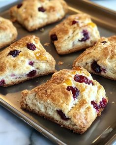 six biscuits with cranberry toppings on a baking sheet