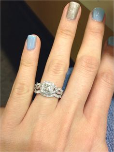 a woman's hand with two rings on it