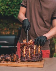 a man is cutting up some meat on a table