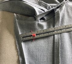 there is a measuring tape on top of a piece of clothing