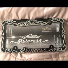 a princess license plate is laying on a bed