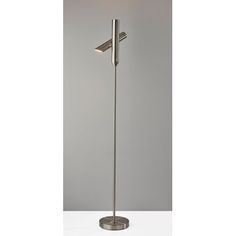 a floor lamp with a white shade on it's head and one light in the middle