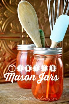 mason jars with wooden spoons and whisk in them