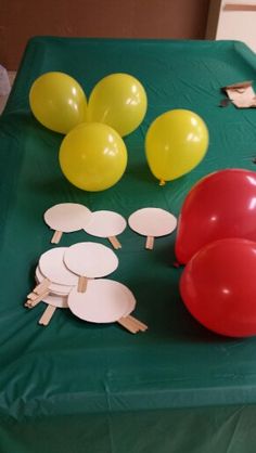 balloons and paper plates on a green table