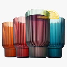 four different colored glass vases sitting next to each other