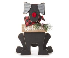 a wooden sign that says welcome with an elephant holding a christmas decoration on it's head