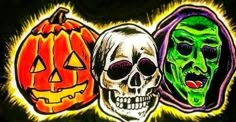 three skulls and two pumpkins with faces painted on the back of their heads, all in different colors