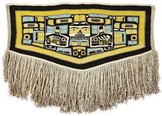 an embroidered wall hanging with fringes and designs on the front, in blue, yellow and black colors