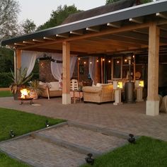 an outdoor living area with patio furniture and lighting