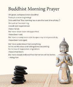 a buddha statue sitting on top of a wooden table next to black and white rocks