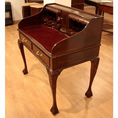 an old piano is sitting on the floor in a room with wooden floors and tables