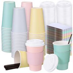 many different colored cups with lids and straws next to each other on a white background