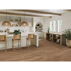 a kitchen with wooden floors and white walls