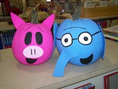 two paper mache pumpkins decorated to look like cartoon characters