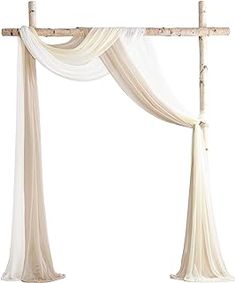 a white canopy with sheer drapes hanging from it's sides