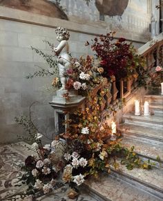 an arrangement of flowers and candles on the stairs