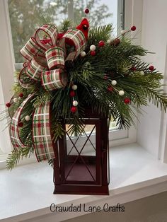 a christmas wreath on top of a window sill