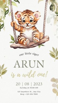 a baby tiger sitting on a swing with leaves around it and the words arun is a wild one