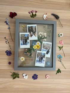 flowers and pictures are arranged in a shadow box on a wooden surface with magnets