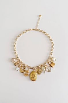 a gold charm bracelet with charms on it