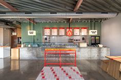 the inside of a restaurant with red and white checkered flooring on the walls