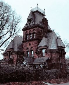 an old brick house with two towers on top