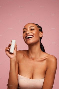 Woman holding a skincare product and smiling Model Holding Product, Holding Product, Fashion Model Poses, Happy Women, Beautiful Skin, Face Wash, Strike A Pose, Model Poses, African Women