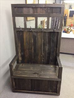 an old wooden bench with metal hooks on it's back and seat is shown