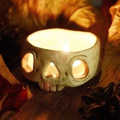 a candle that has been placed in the shape of a skull with two eyes on it