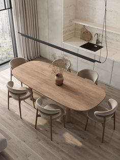 a dining room table with chairs and a potted plant on the top of it