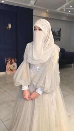 a woman in a white hijab and dress