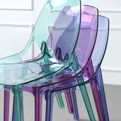 the chairs are stacked on top of each other and have different colored plastic coverings