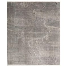 a gray rug with wavy lines on it