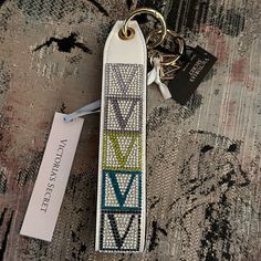 a keychain with an arrow design on it and a tag attached to it