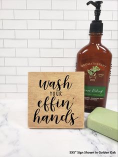 a bottle of soap next to a sign that says life is short lick the bow but not this one