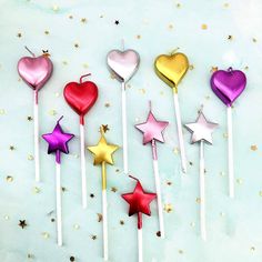 six heart shaped lollipops with stars on them